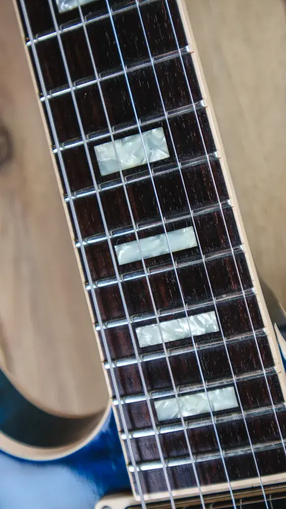 Thumbnail: Detail of the 2018 Gibson Memphis ES-335 fretboard with pearloid block inlays.
