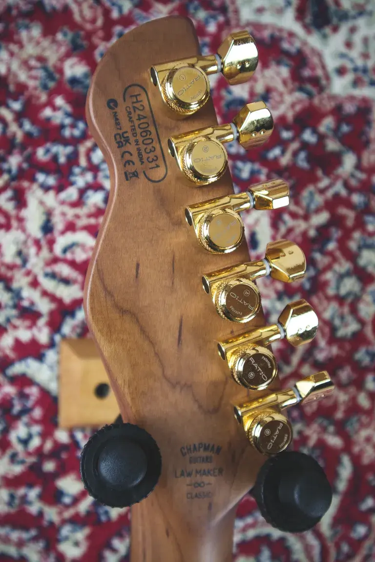 Thumbnail: Rear headstock of Chapman Lawmaker Classic showing gold Ratio tuners and manufacturer markings.