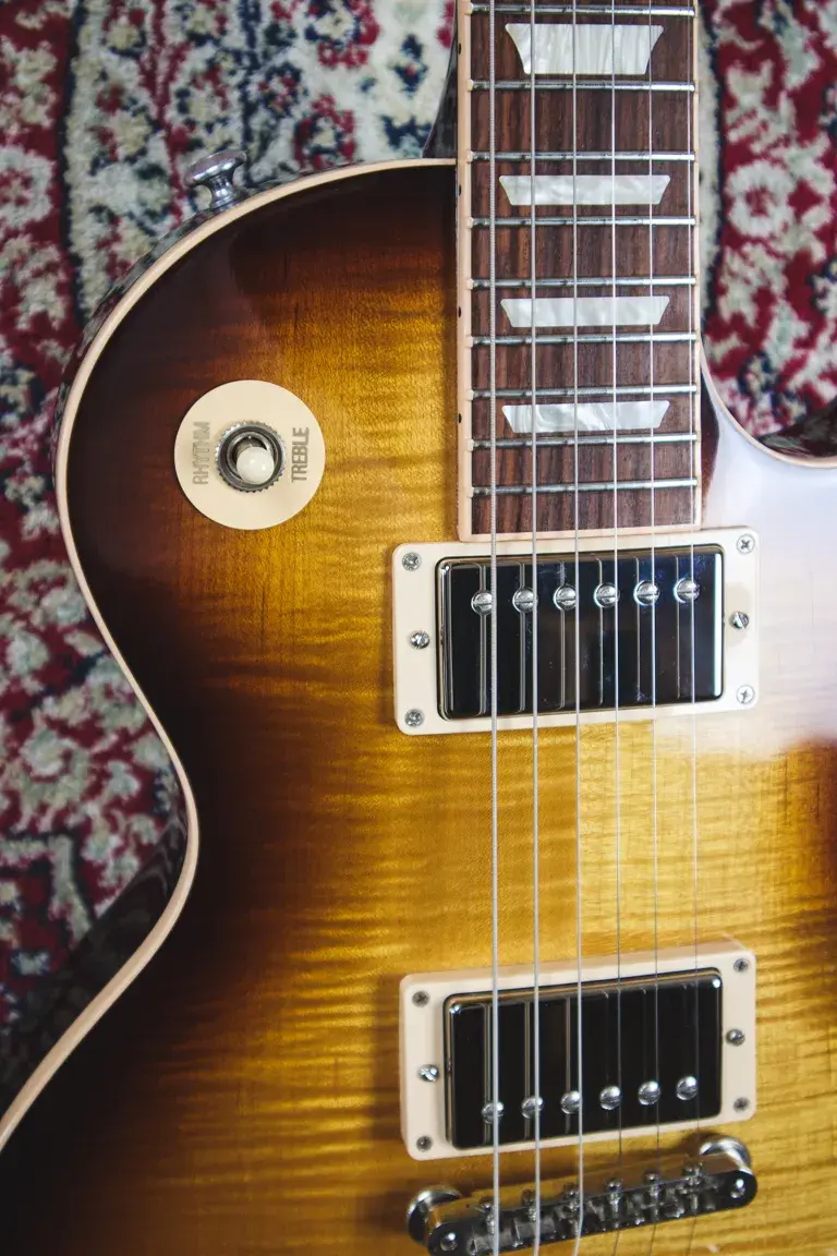 Thumbnail: Upper body and pickup selector switch on Gibson Les Paul Traditional with flame maple detail