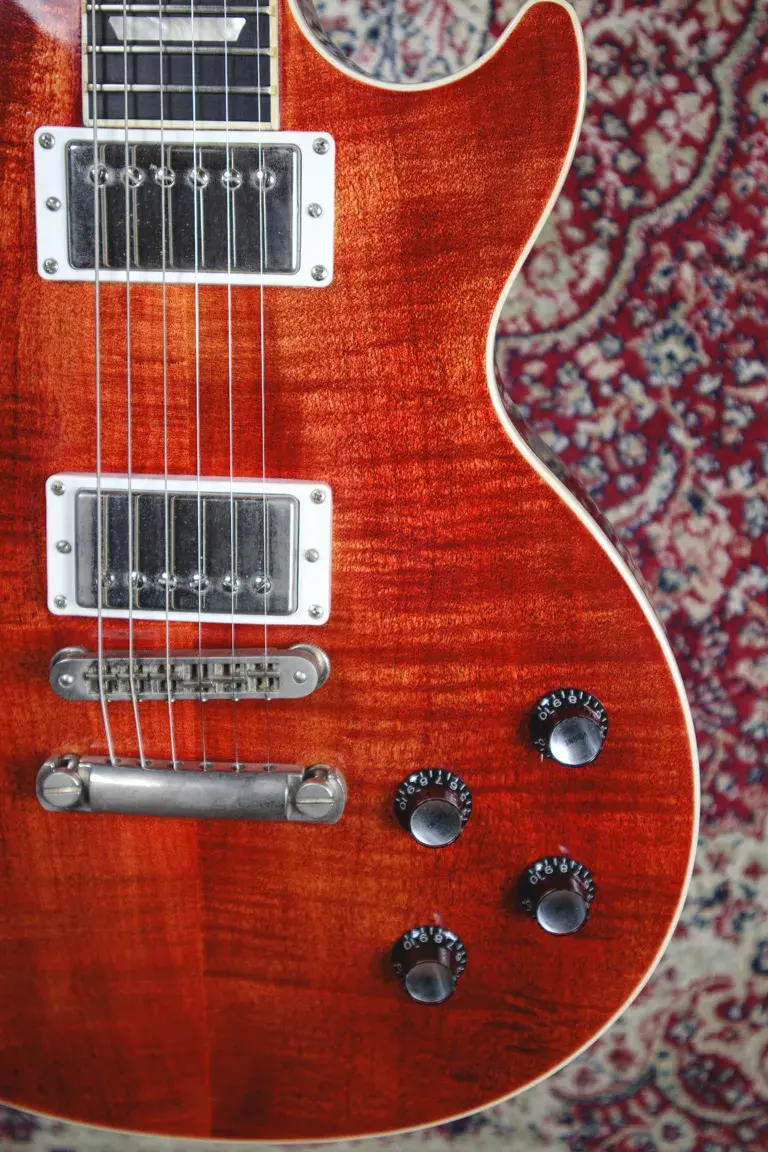 Thumbnail: Lower body close-up of a 2005 Gibson Les Paul Santa Fe showing flame maple top, humbucker, and volume/tone knobs.