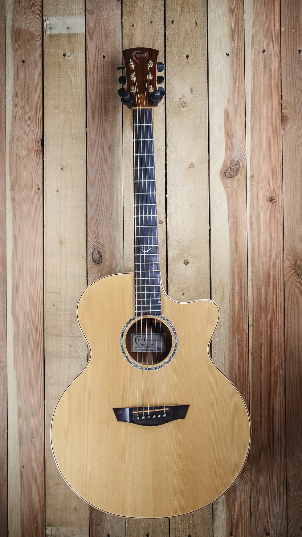 Front view of the Faith Natural Series Jupiter Cutaway FJCE, showcasing its elegant body shape and finish
