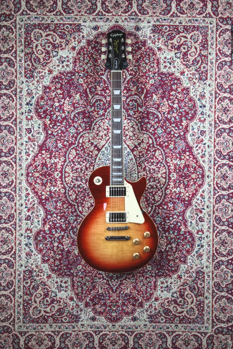 Full front view of Epiphone Les Paul Standard on ornate rug