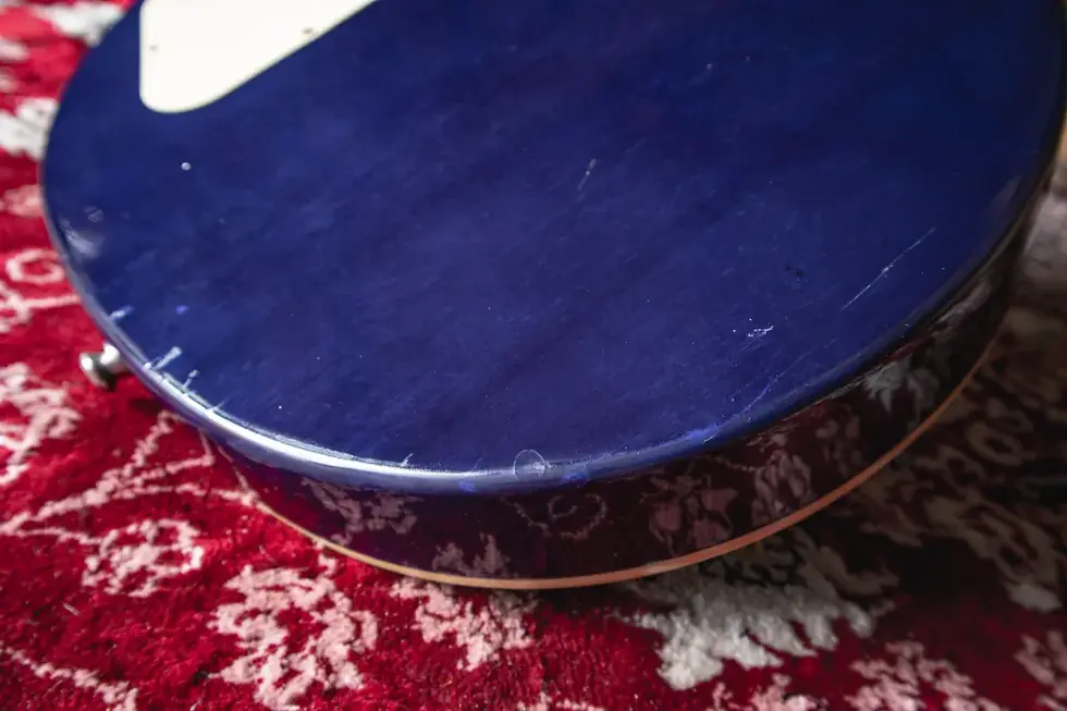 Thumbnail: Close-up of the body showing natural wear and tear on the Epiphone Les Paul STD 2008 Translucent Blue Burst guitar.