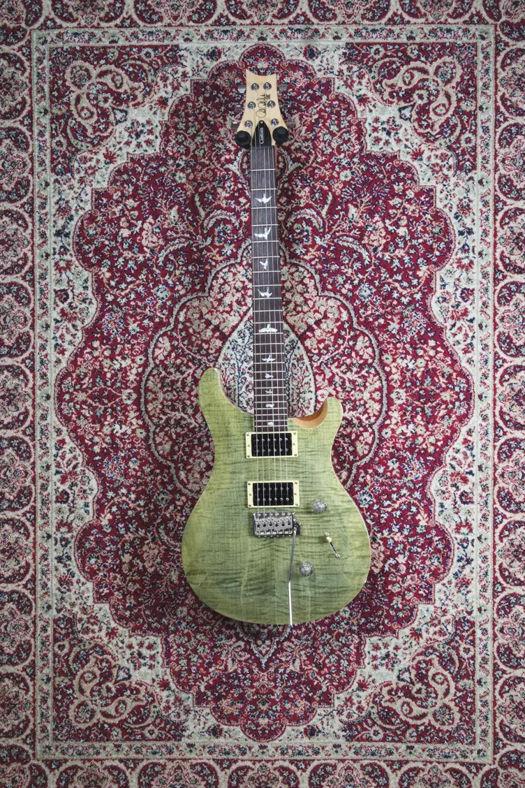 Front of PRS SE Custom 24 in Trampas Green with bird inlays