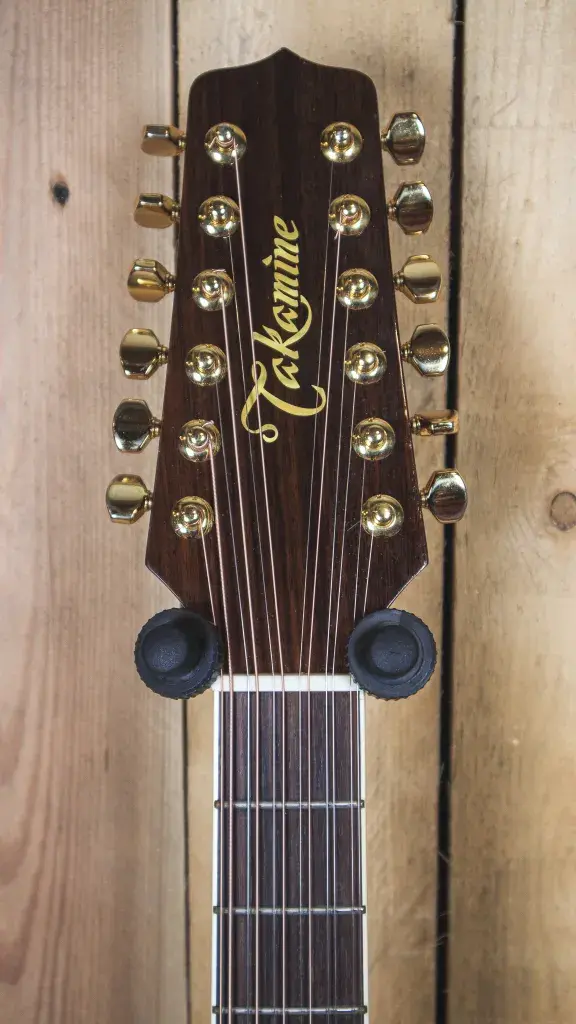 Thumbnail: Close-up of the headstock with the Takamine logo and 12-string tuning pegs, showcasing the iconic branding and hardware.