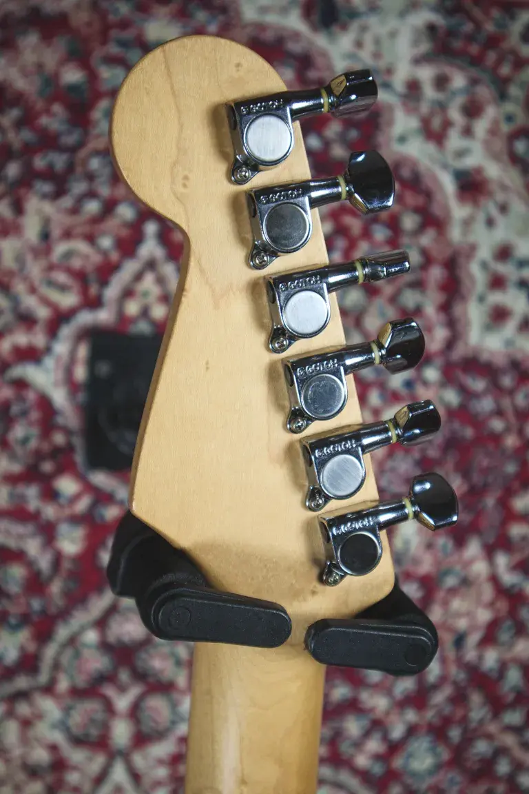 Thumbnail: Rear headstock of a 1993 Squier Silver Series Stratocaster showing tuners and neck grain.
