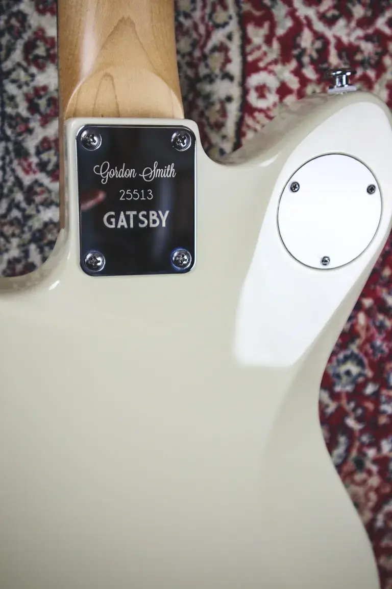 Thumbnail: Neck plate on the back of the guitar engraved with “Gordon Smith 25513 GATSBY”.