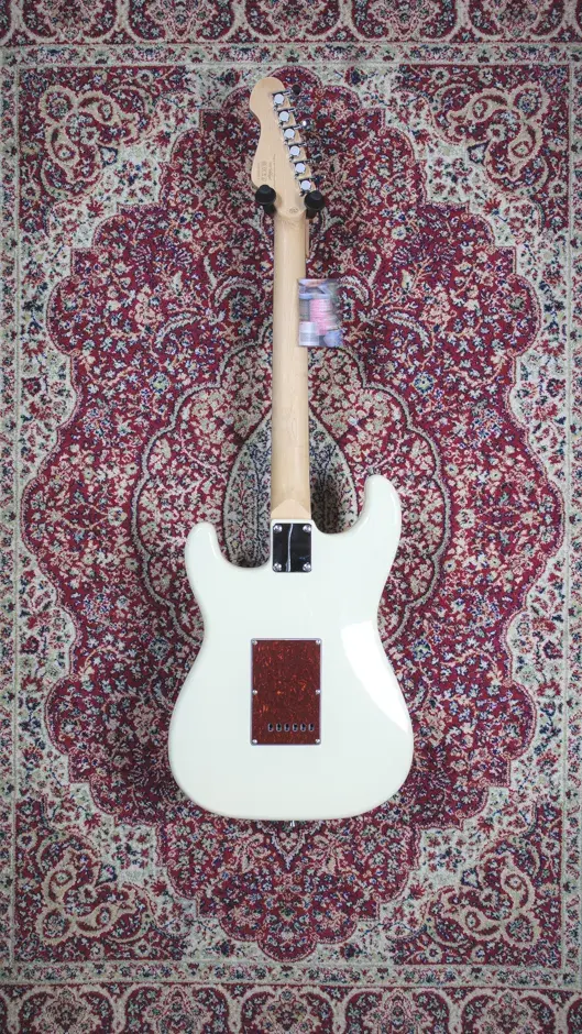 Rear view of the Vintage V60 Coaster Series guitar, showcasing its white finish and back contour.