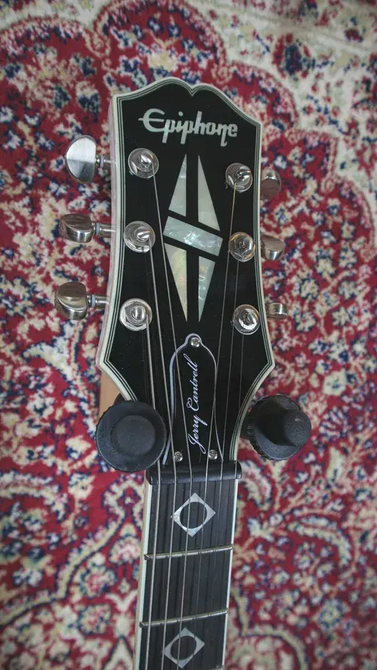 Thumbnail: Close-up of the headstock front, featuring the Epiphone logo and detailed inlays.