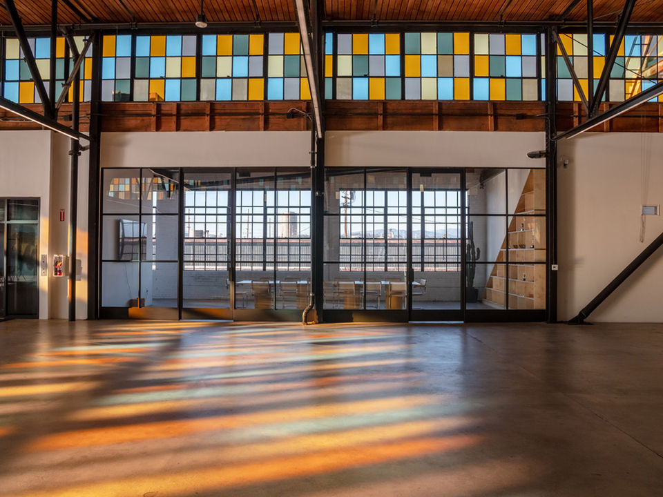 Renovated 1924 paper company's open space with colorful vintage stained glass windows. creative offices - The Feel interior design Los Angeles