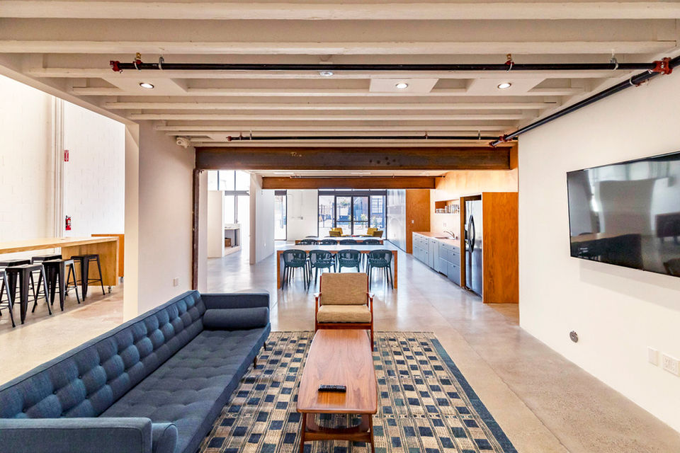 Revitalized '90s Block Building Interior: Welcoming lounge area, Dynamic Layout, Industrial Charm - The Feel Interior Design Los Angeles
