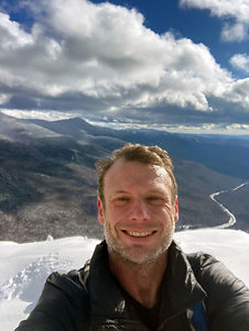 A breathtaking outdoor moment as Nick Gosling stands atop a scenic mountain, embracing nature and adventure. A symbol of resilience and connection to the outdoors.