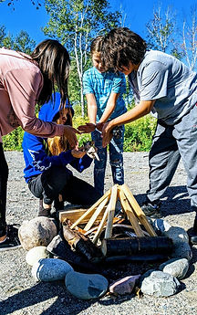 Students learning to build a fire