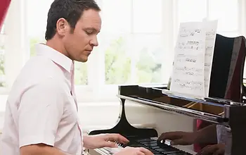 An adult practicing on a grand piano
