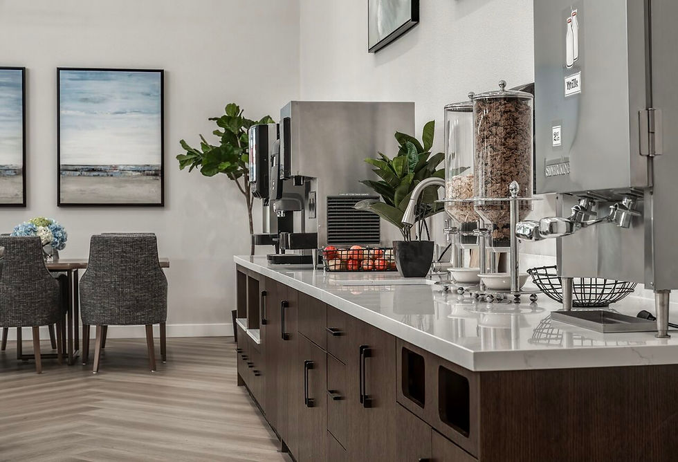 Breakfast bar with coffee machines, cereal dispensers, and framed art