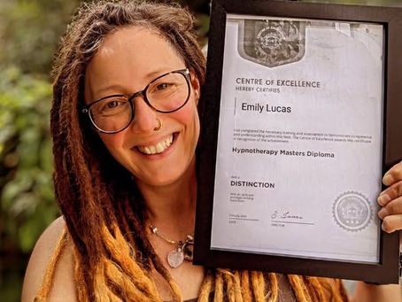 Em Lucas a year ago, holding her hypnotherapy master's diploma.