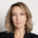 a blond woman in a black suit for a corporate headshot