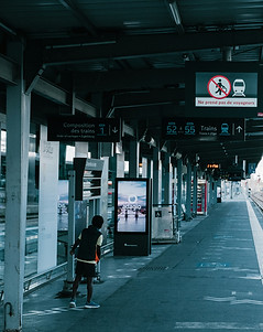 a man and a woman walking in a large bui