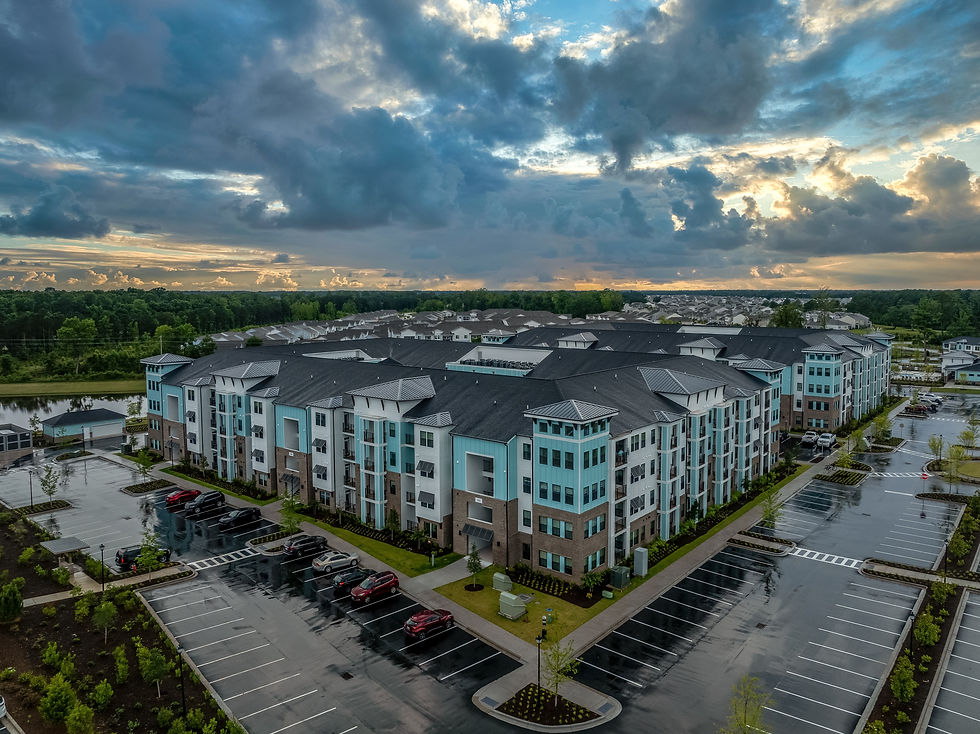 Aerial view of modern American apartment condo complex with turquoise vinyl siding dramati