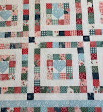 From the Heart quilt featuring blue heart fabric designs”