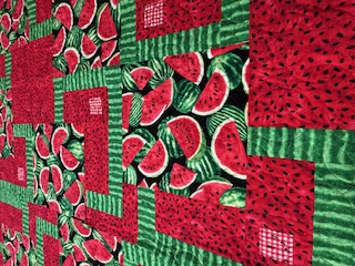 Close-up of Easy BQ7 quilt pattern with pink and green watermelon fabric