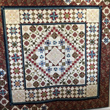 Handmade Waltham Forrest quilt with woodland fabric and earthy tones