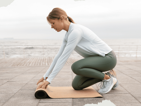 Menopausal woman unrolling a yoga mat