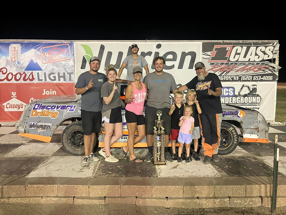 A picture of Tathan Burkhart in victory lane at RPM Speedway in Hays, Kansas!