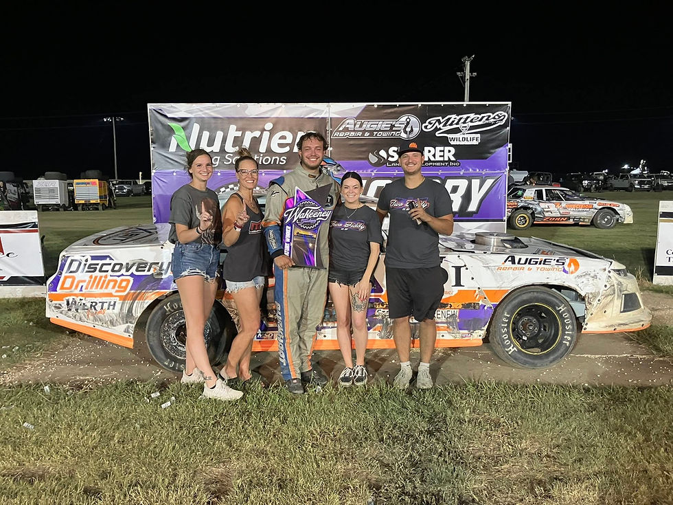 A picture of Tathan Burkhart in victory lane at WaKeeney Speedway!
