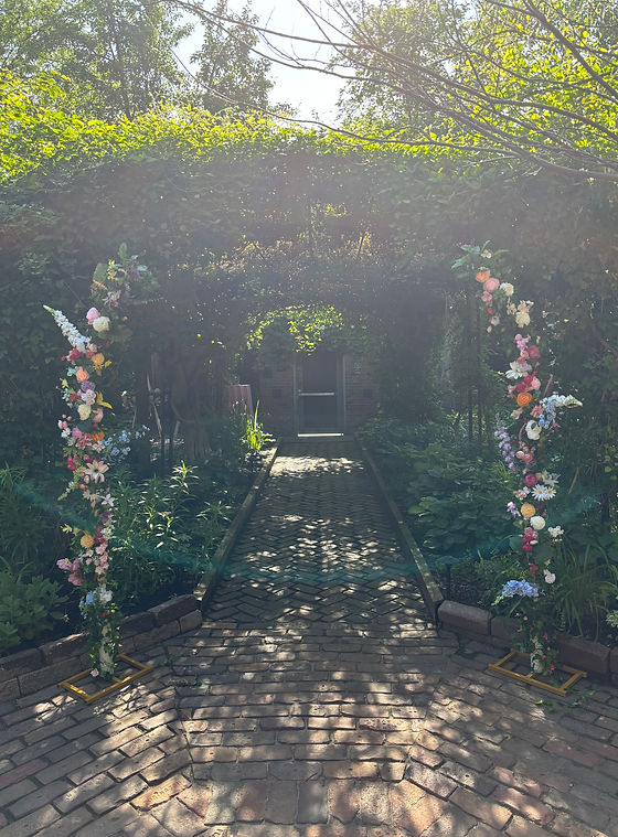 A photo of a flower arch for a wedding