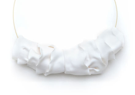 a white necklace with a gold wire around it