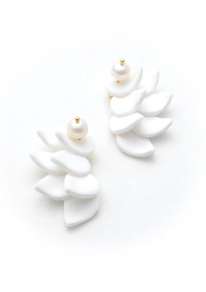 a pair of white earrings with pearls on them
