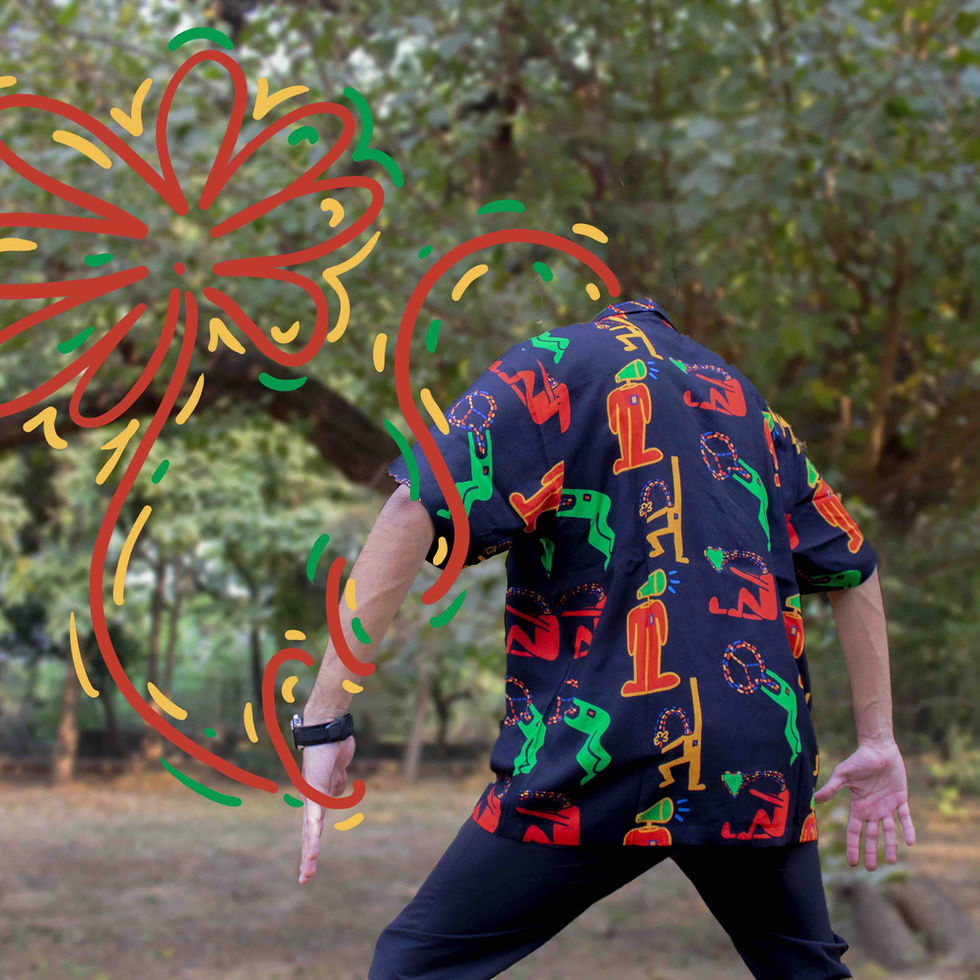 A man/woman with a flower head, keith haring shirt, in front of a forest
