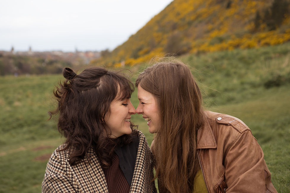 Two girls, a couple, grinning nose to nose