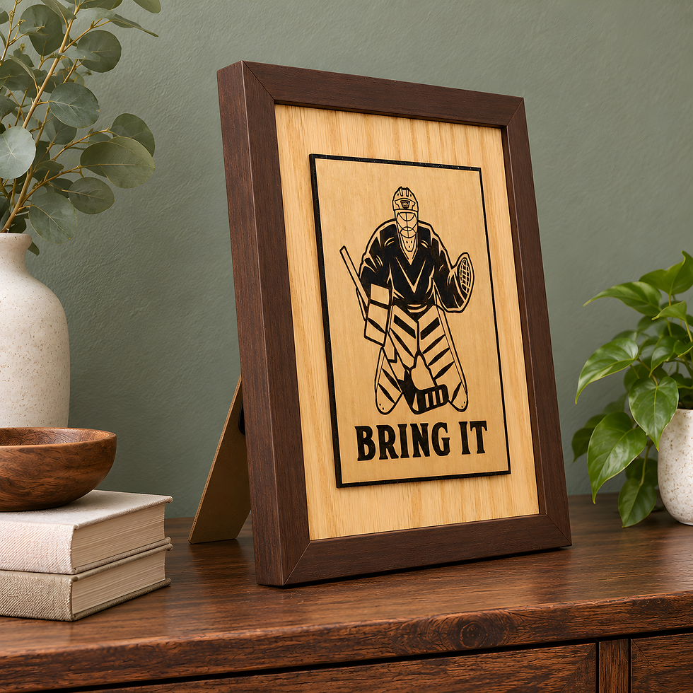 Brown framed hockey goalie wood sign with Bring It lettering and raised birch artwork displayed against a sage green wall.