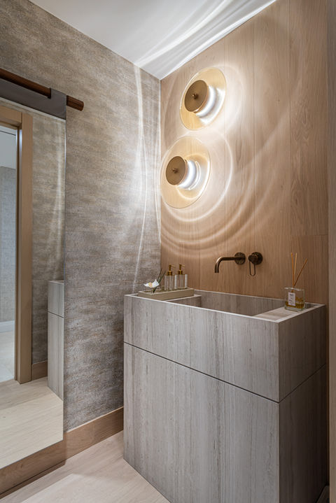 Modern powder room with stone sink and unique wall decor