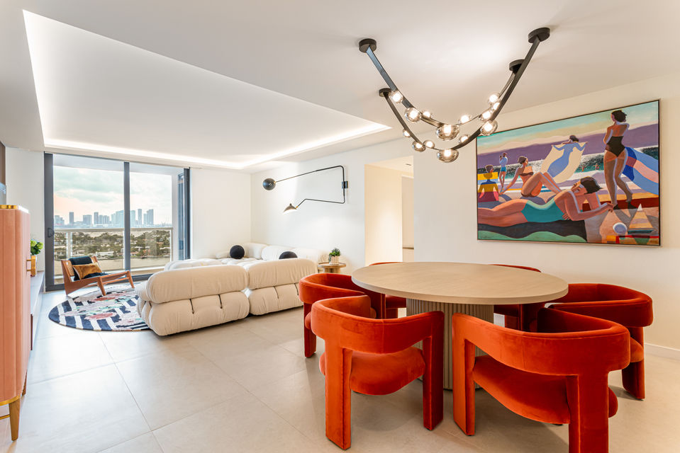 Modern living room with orange chairs and artwork