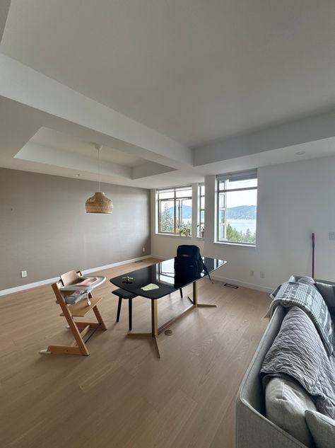 Light oak hardwood flooring with a smooth, matte finish, giving the space a warm and natural feel.