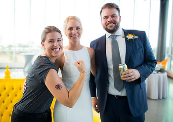 Gainesville wedding planner, Rachel Griffin with MasterPiece Weddings, flexes to show off her temporary wedding favor tattoo of the bride and groom.