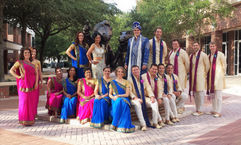 An Indian wedding party in colorful wedding sari's with the Albert & Alberta statues at the University of Florida