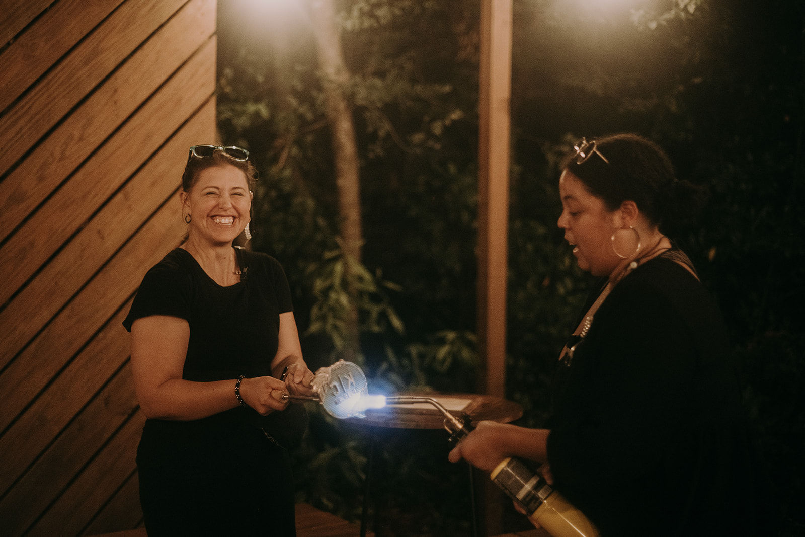 Wedding coordinators using a blow torch to heat up a metal utensil for a unity brand