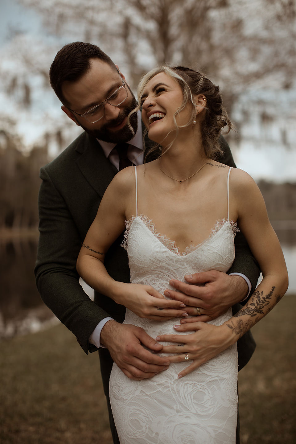 Couple embracing while laughing on their wedding day