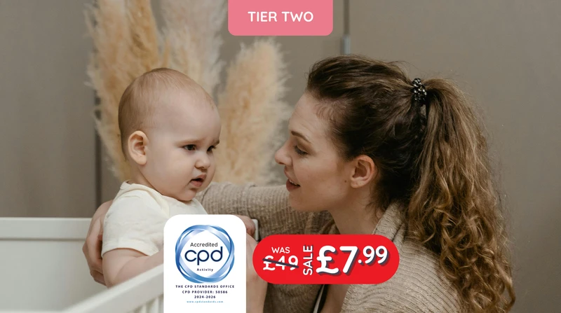a woman holds a baby in a crib with a tier two logo behind her
