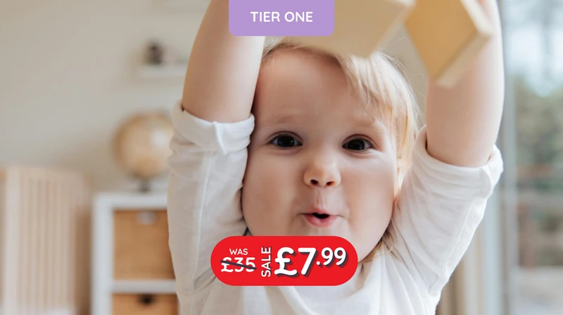 a baby is playing with a purple tier one sign