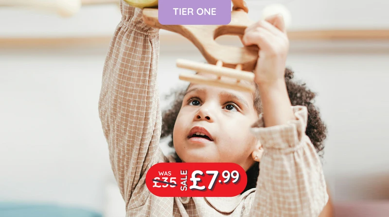 a little girl is playing with a wooden toy and the words tier one are above her