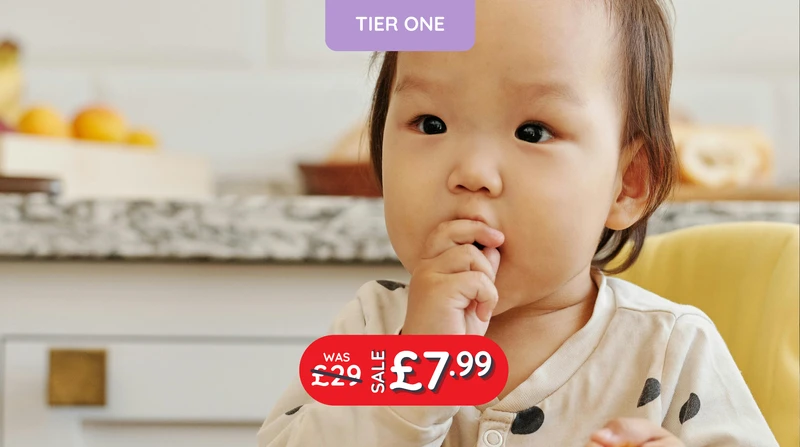 a baby with a purple sign that says tier one