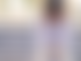 A stressed healthcare admin sitting on the stairs while rubbing her temples.