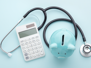 A light blue piggy bank with a calculator and a stethoscope
