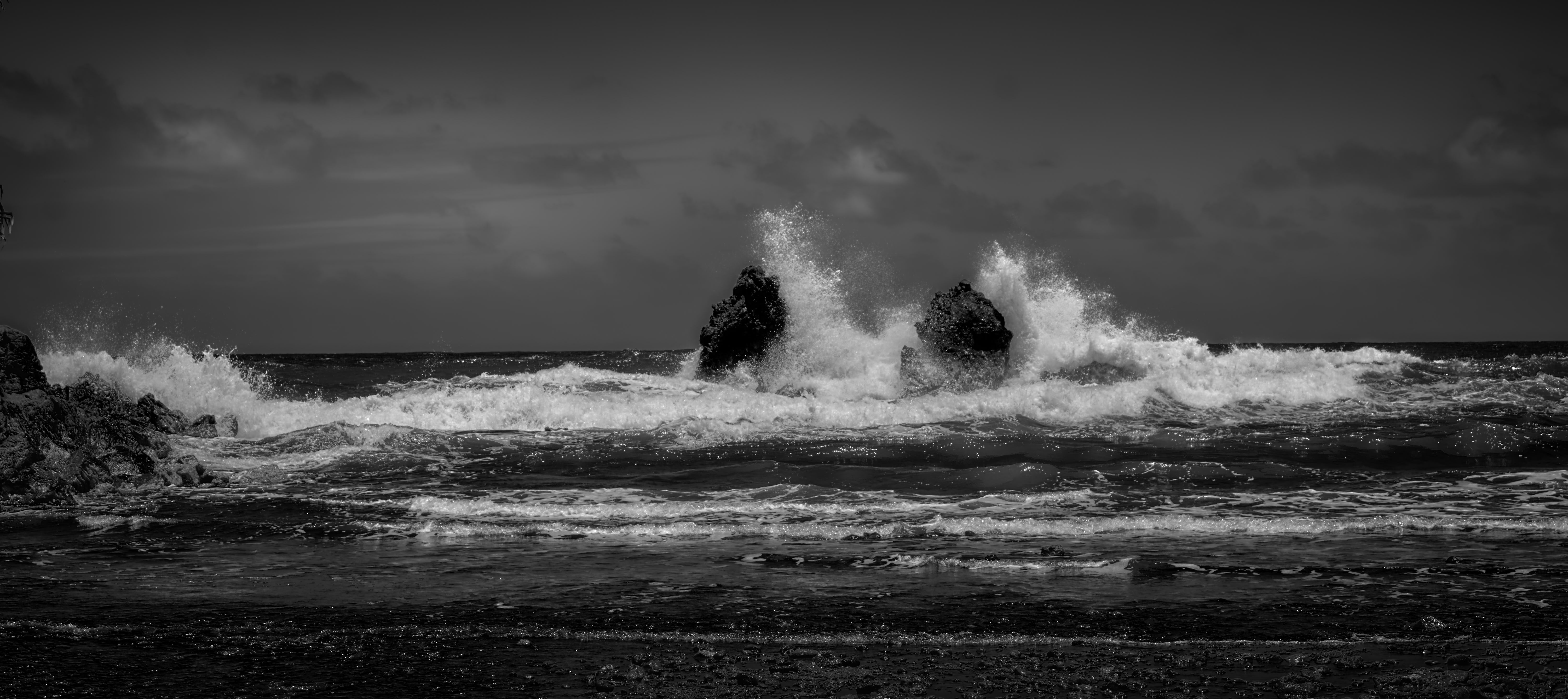 Unusually high surf in Onomea Bay attacks the Twin Rocks that, by legend, defend Onomea Bay