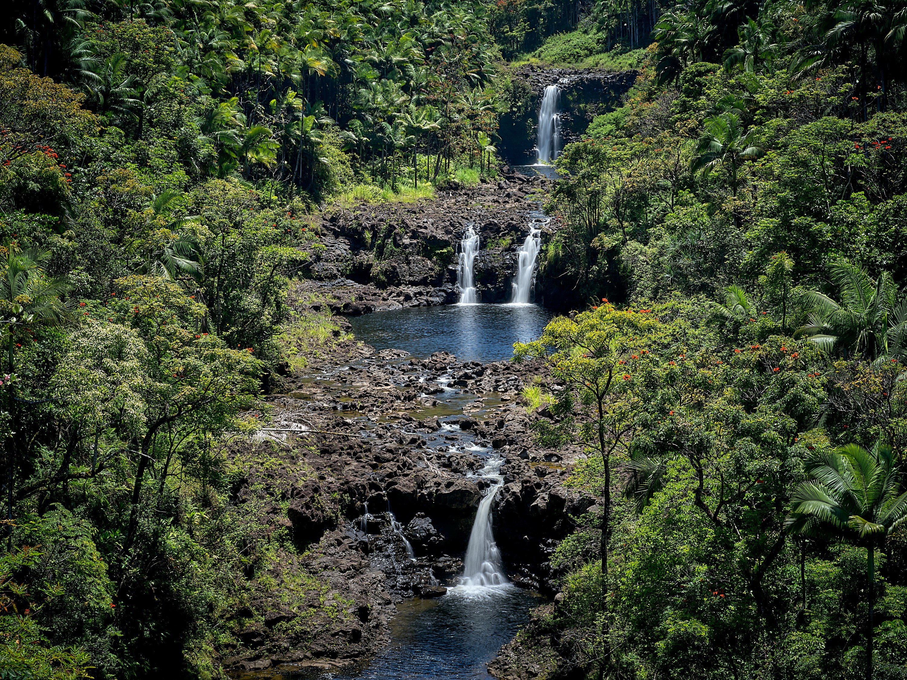 Seen from a viewpoint in the park, the three falls cascade down the Umauma River
